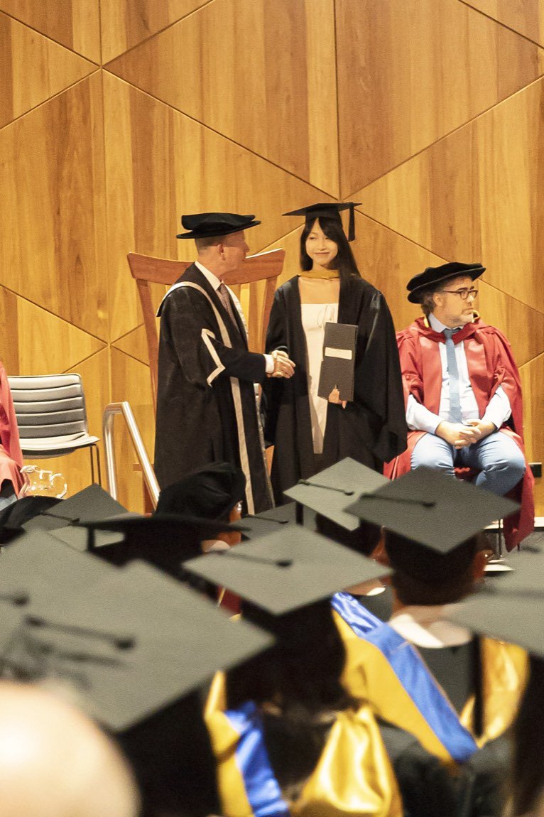 Graduate receiving her testamur on stage